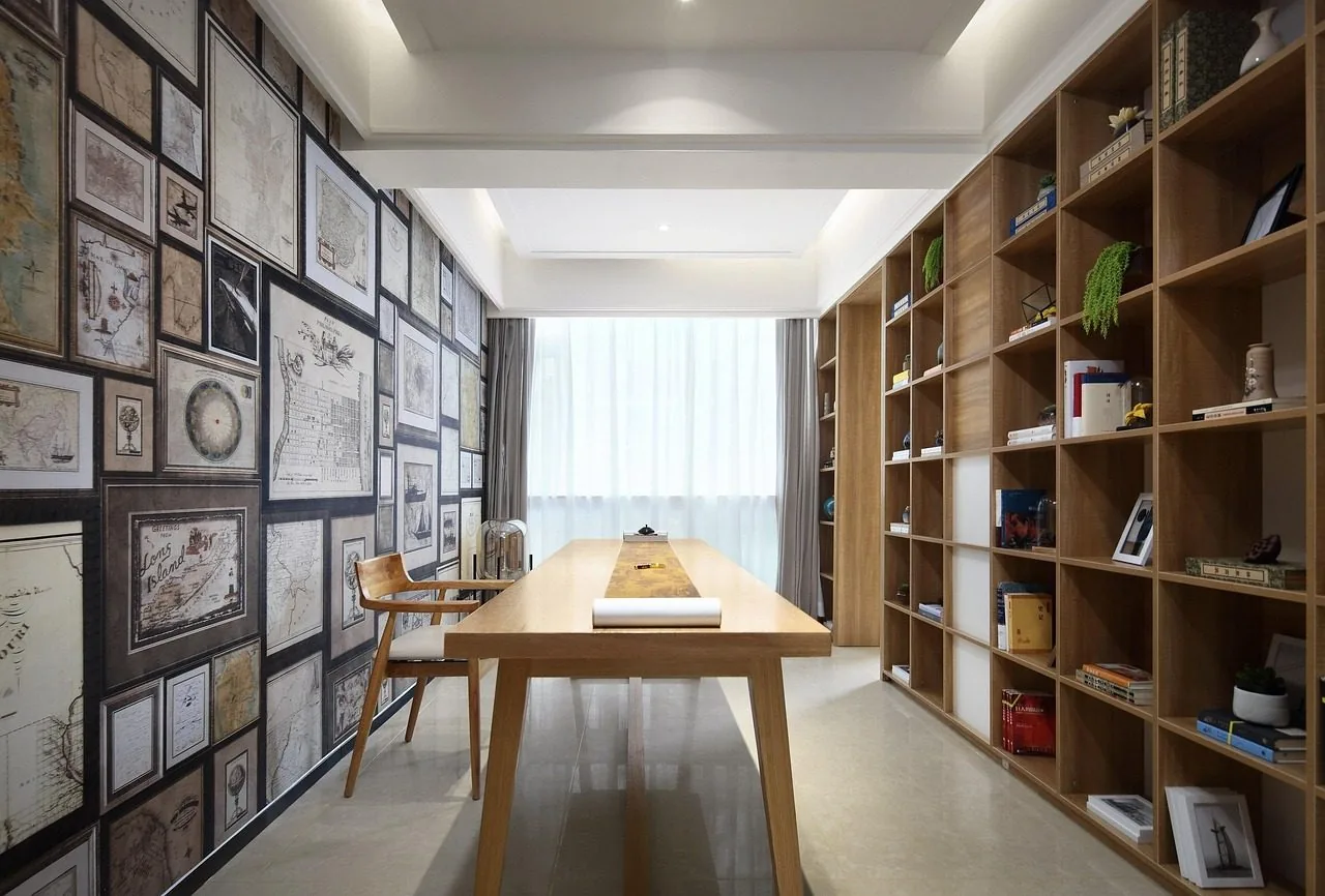 A white bookcase with books and a few boxes on the shelves